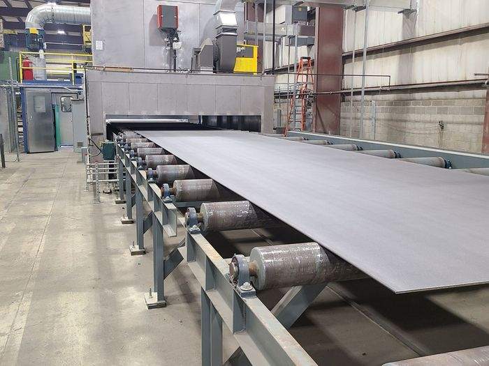 Steel plate moving through the automated blast and prime plate line