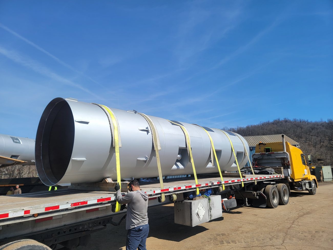 Coated steel vessel strapped to a flatbed trailer at the Regal Industrial facility